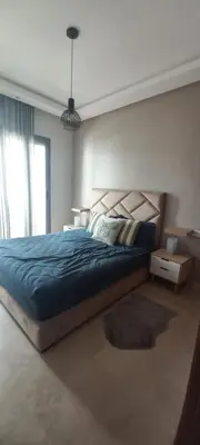 a bedroom with a bed with a blue comforter at Cozy 1BR 1BA Retreat in Casablanca