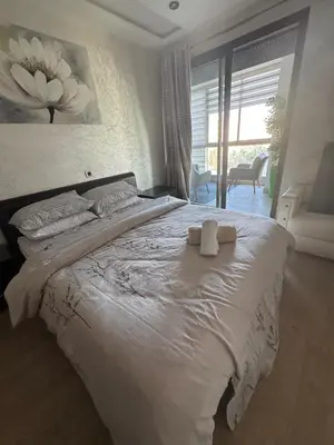 a bedroom with a bed with two towels on it at Appartement 3 chambres moderne a californie Casablanca in Casablanca