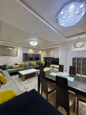 a living room with a couch and a table at Appartement 3 chambres moderne a californie Casablanca in Casablanca