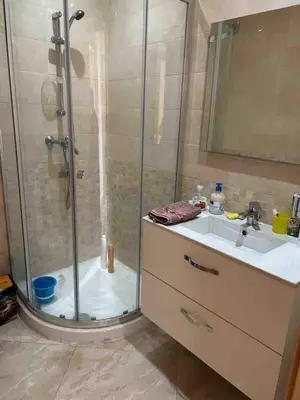 a bathroom with a shower and a sink at Beautiful apartment with pool & beach nearby in Bouznika