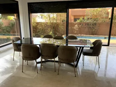 a dining room with a glass table and chairs at Beachfront Villa in Dar Bouazza in Dar Bouazza