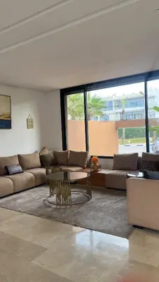 a living room with a couch and a table at Beachfront Villa in Dar Bouazza in Dar Bouazza