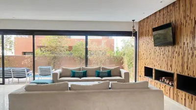 a living room with a couch and a large window at Beachfront Villa in Dar Bouazza in Dar Bouazza