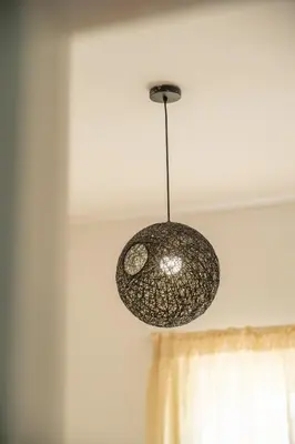 a pendant light hanging from a ceiling at Serene 2 BR Apt Steps from Parks & Casa Finance City in Casablanca