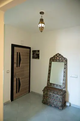 a room with a mirror next to a door at Serene 2 BR Apt Steps from Parks & Casa Finance City in Casablanca