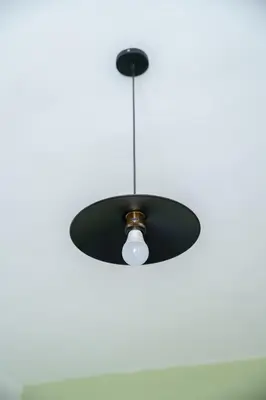 a black ceiling light hanging from a ceiling at Serene 2 BR Apt Steps from Parks & Casa Finance City in Casablanca