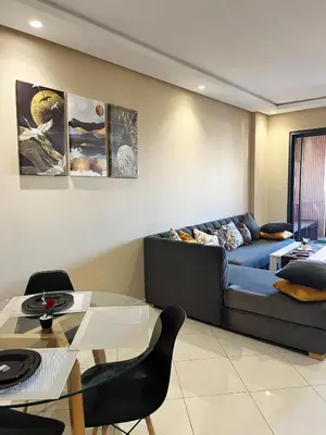 a living room with a couch and a table at Modern studio near stadium Mohamed V AFCON 2025 in Casablanca
