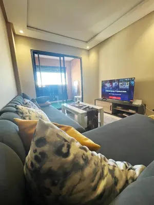a living room with a couch and a flat screen tv at Modern studio near stadium Mohamed V AFCON 2025 in Casablanca