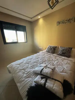 a large white bed in a bedroom with a window at Modern studio near stadium Mohamed V AFCON 2025 in Casablanca