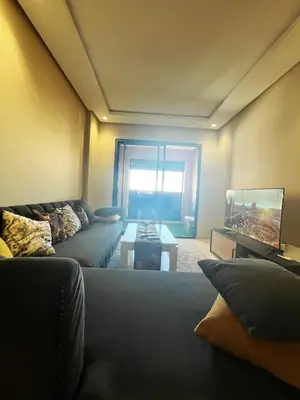 a living room with a couch and a table at Modern studio near stadium Mohamed V AFCON 2025 in Casablanca
