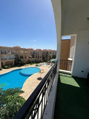 a balcony of a building with a swimming pool at Mansouria Ricoflores beach vue mer et piscine in Mansouria
