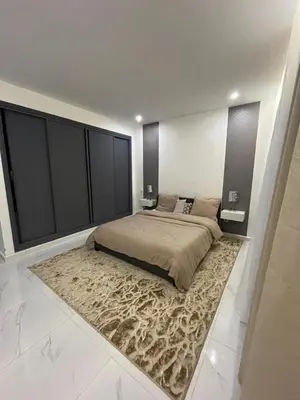 a bedroom with a large bed and a large rug at Mansouria Ricoflores beach vue mer et piscine in Mansouria