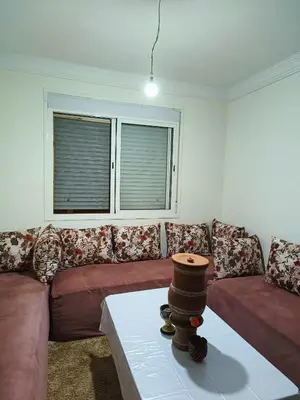 a living room with a couch and a table at Shams sidi rahal in Sidi Rahal