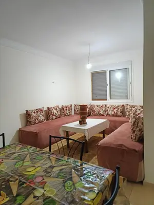 a room with two beds and a table and a couch at Shams sidi rahal in Sidi Rahal