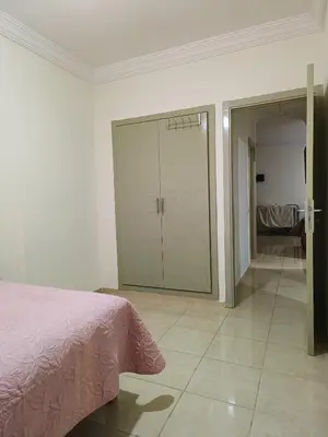 a bedroom with a bed and a sliding glass door at Shams sidi rahal in Sidi Rahal