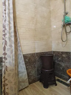 a bathroom with a shower with a toilet and a shower curtain at Shams sidi rahal in Sidi Rahal
