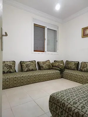 a living room with a couch and a window at Shams sidi rahal in Sidi Rahal