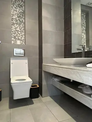 a bathroom with a toilet and a sink at Appartement luxueux prestigia in Rabat