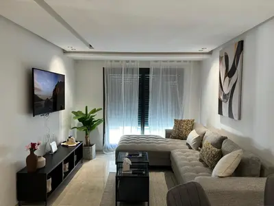 a living room with a couch and a table at Elegance & Comfort - Les Princesses District in Casablanca