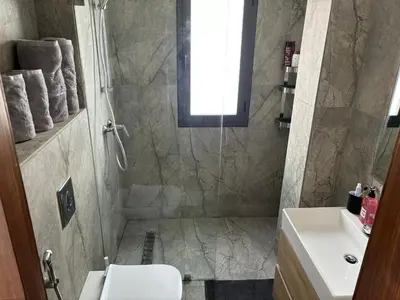 a bathroom with a shower and a toilet and a sink at Elegance & Comfort - Les Princesses District in Casablanca