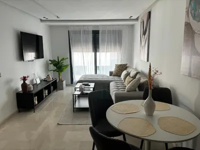 a living room with a couch and a table at Elegance & Comfort - Les Princesses District in Casablanca