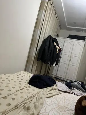 a bedroom with a bed and clothes hanging on a closet at Appart Marina Beach in Pont Blondin