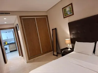 a bedroom with a bed and a sliding door at Emma's Luxury Studio 36 in Casablanca