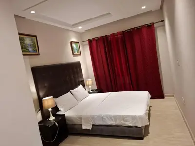 a bedroom with a large bed with red curtains at Emma's Luxury Studio 36 in Casablanca