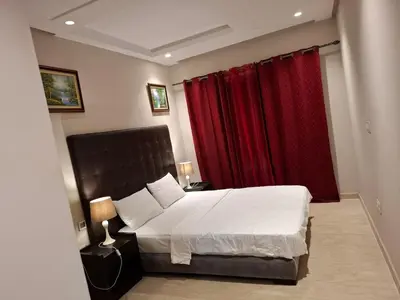 a bedroom with a large bed with red curtains at Emma's Luxury Studio 36 in Casablanca
