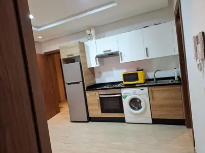 a kitchen with a white refrigerator and a washing machine at Emma's Luxury Studio 36 in Casablanca
