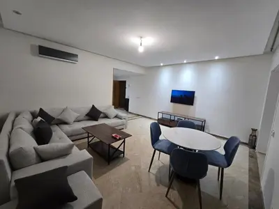 a living room with a couch and a table at Les Perles de Bentriaa Mohammedia in Mohammedia