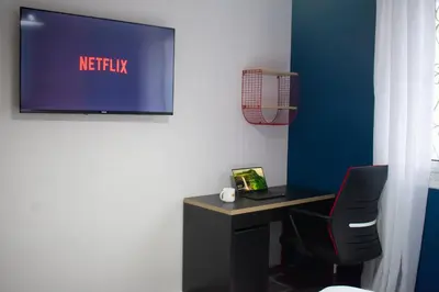 a desk with a chair and a tv on a wall at In the Heart of Casablanca in Casablanca