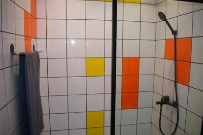 a bathroom with a shower with colorful tiles at In the Heart of Casablanca in Casablanca