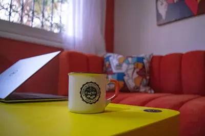 a coffee cup sitting on a table next to a laptop at In the Heart of Casablanca in Casablanca