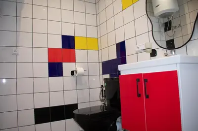 a bathroom with a red cabinet and a toilet at In the Heart of Casablanca in Casablanca