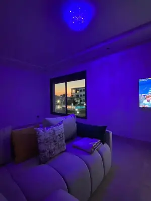 a purple living room with a purple couch in a room at Aymen beach in Mansouria