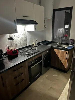 a kitchen with a sink and a stove top oven at Aymen beach in Mansouria