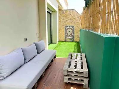 a living room with a couch and a table at Appt Centre ville Casablanca Maarif avec Terrasse in Casablanca
