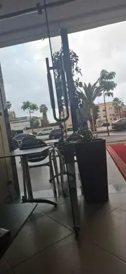 a table and chairs sitting in front of a window at الهرهورة in Oulad Kerroum