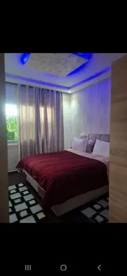 a bedroom with a large bed with a red blanket at Appartemment à Rabat Agdal Avenue de France in Rabat