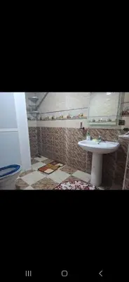 a bathroom with a sink and a toilet and a mirror at Appartemment à Rabat Agdal Avenue de France in Rabat