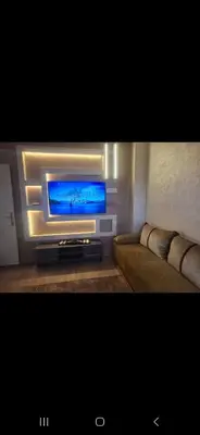 a living room with a television and a couch at Appartemment à Rabat Agdal Avenue de France in Rabat