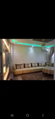 a living room with a long couch in a room at Appartemment à Rabat Agdal Avenue de France in Rabat