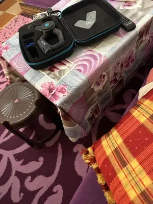 a table with a controller sitting on top of it at Emplacement idéal chambre Privée in Rabat