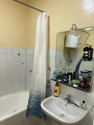 a bathroom with a sink and a tub and a mirror at Emplacement idéal chambre Privée in Rabat