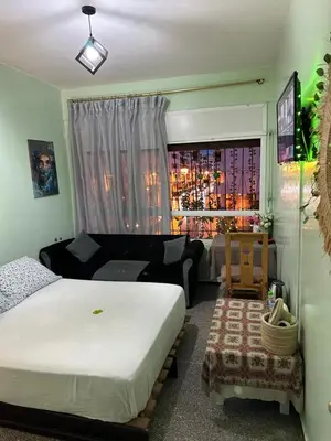 a bedroom with a bed and a couch and a window at Emplacement idéal chambre Privée in Rabat