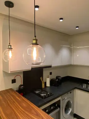 a kitchen with two pendant lights over a counter at Luxury apartment in Downtown Casablanca in Casablanca