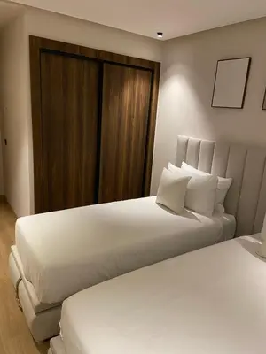 a bedroom with two beds with white sheets and a window at Luxury apartment in Downtown Casablanca in Casablanca