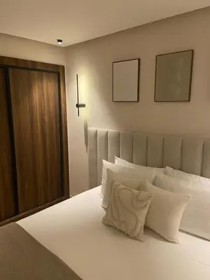 a bedroom with a large bed with white pillows at Luxury apartment in Downtown Casablanca in Casablanca