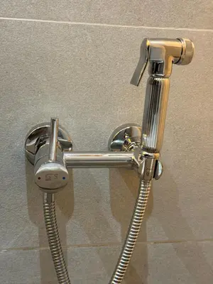 a metal shower head and hose in a bathroom at Ksar Labhar Second Nest in Rabat
